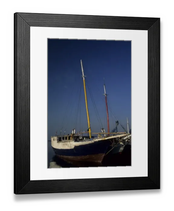 Framed Print : Indonesia, Sulawesi, Ujung Pandang. Bugis pinisi schooners docked at Paotere Harbor