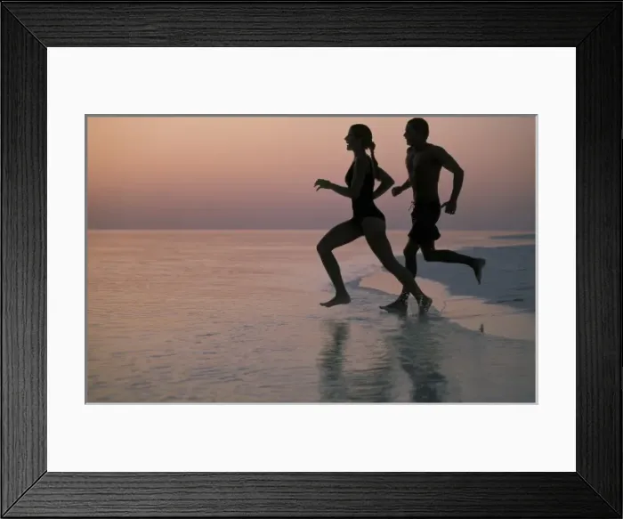 Framed Print : Asia, Maldives. Couple running on beach (MR)