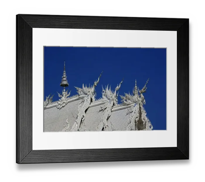 Framed Print : Rooftop architectural details of the new all white temple of Wat Rong Khun in Tambon Framed Print : Rooftop architectural details of the new all white temple of Wat Rong Khun in Tambon