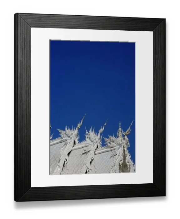 Framed Print : Rooftop architectural details of the new all white temple of Wat Rong Khun in Tambon Framed Print : Rooftop architectural details of the new all white temple of Wat Rong Khun in Tambon