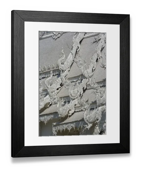 Framed Print : Rooftop architectural details of the new all white temple of Wat Rong Khun in Tambon Framed Print : Rooftop architectural details of the new all white temple of Wat Rong Khun in Tambon