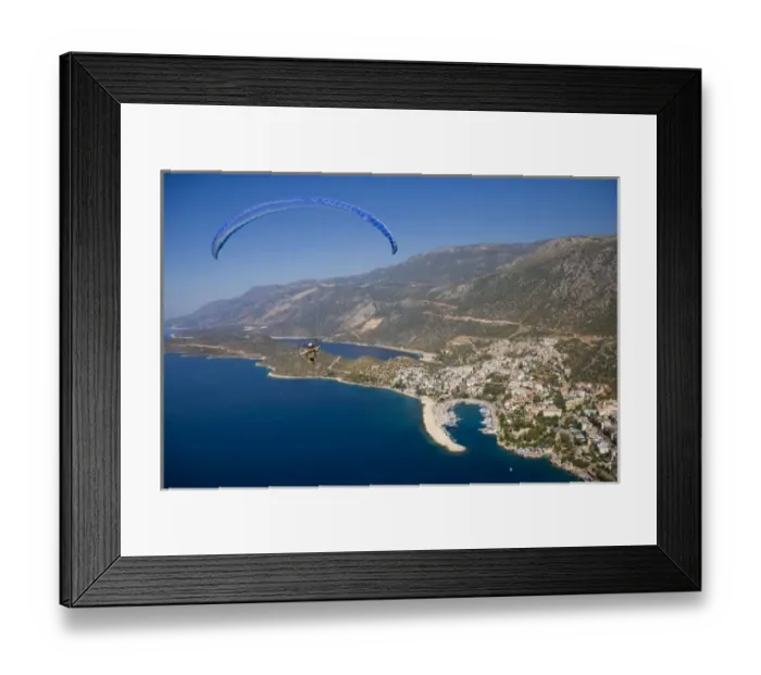 Framed Print : Powered paraglider flying over Kas, aerial view, Antalya, Turkey Framed Print : Powered paraglider flying over Kas, aerial view, Antalya, Turkey