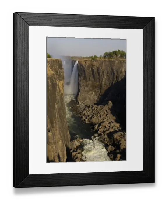Framed Print : Victoria Falls. Border of Zimbabwe and Zambia. The largest waterfall in Africa. ZIMBABWE Framed Print : Victoria Falls. Border of Zimbabwe and Zambia. The largest waterfall in Africa. ZIMBABWE
