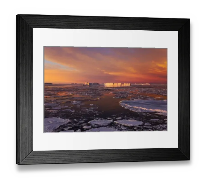 Framed Print : Huge iceberg and ice floes in the ocean at sunrise, Antarctica