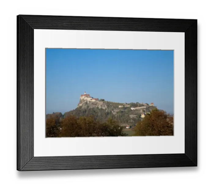Framed Print : Austria - Low angle view of a village built on a mountaintop. Horizontal shot