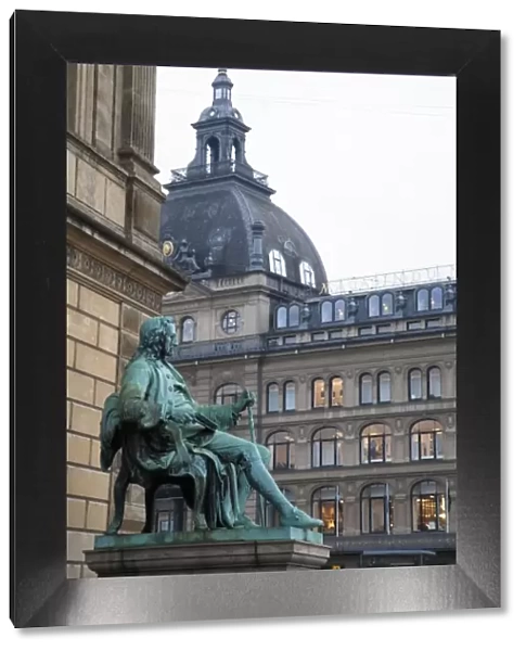 Copenhagen, Denmark - A statue of a man sitting in a chair wearing 18th century clothes