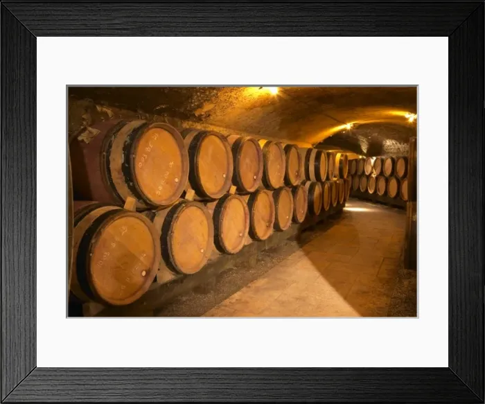 Framed Print : Wooden barrels with aging wine in an underground corridor in the cellar of Guigal in Ampuis Framed Print : Wooden barrels with aging wine in an underground corridor in the cellar of Guigal in Ampuis