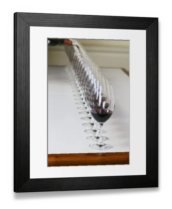 Framed Print : A straight row of glasses lined up for tasting being filled up with red wine - Chateau Framed Print : A straight row of glasses lined up for tasting being filled up with red wine - Chateau