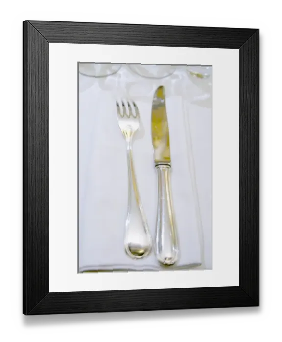 Framed Print : Knife and fork on a white linen napkin and table cloth in the restaurant Le Gourmandin