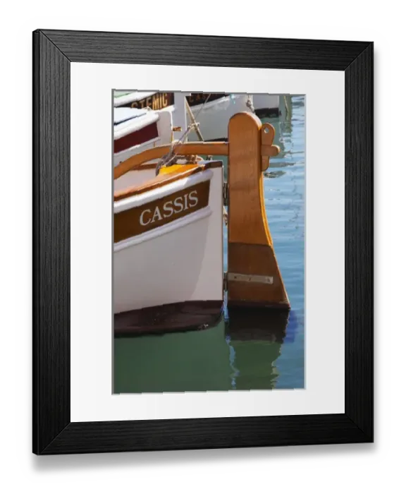 Framed Print : In the harbour in Cassis village. A traditional style boat with wooden rudder marked Framed Print : In the harbour in Cassis village. A traditional style boat with wooden rudder marked