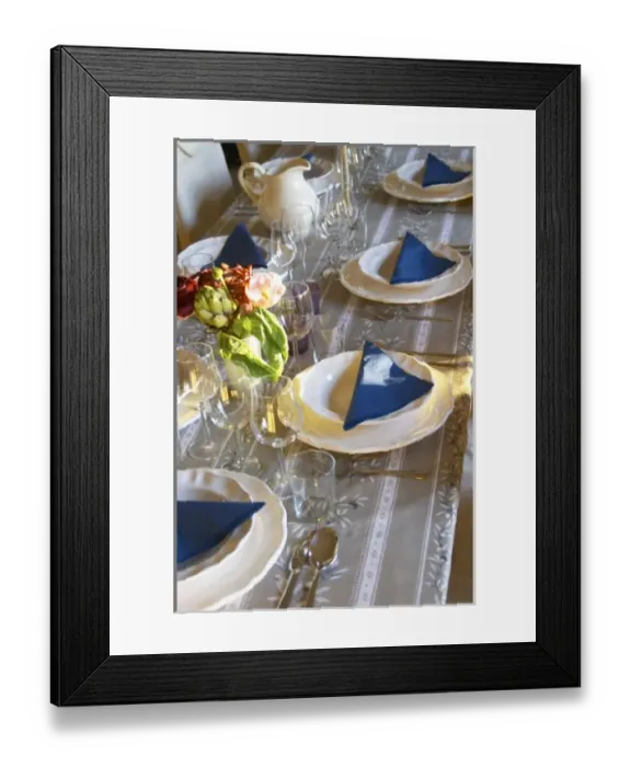Framed Print : The dining room table set with flowers and decorative vegetables for dinner guests