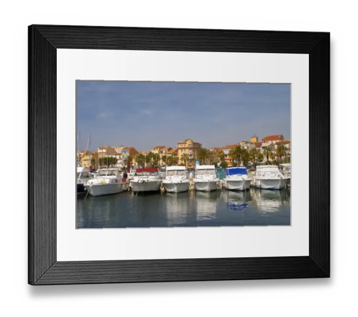 Framed Print : The harbour with boats and buildings along the water in Bandol. White motor yachts Framed Print : The harbour with boats and buildings along the water in Bandol. White motor yachts