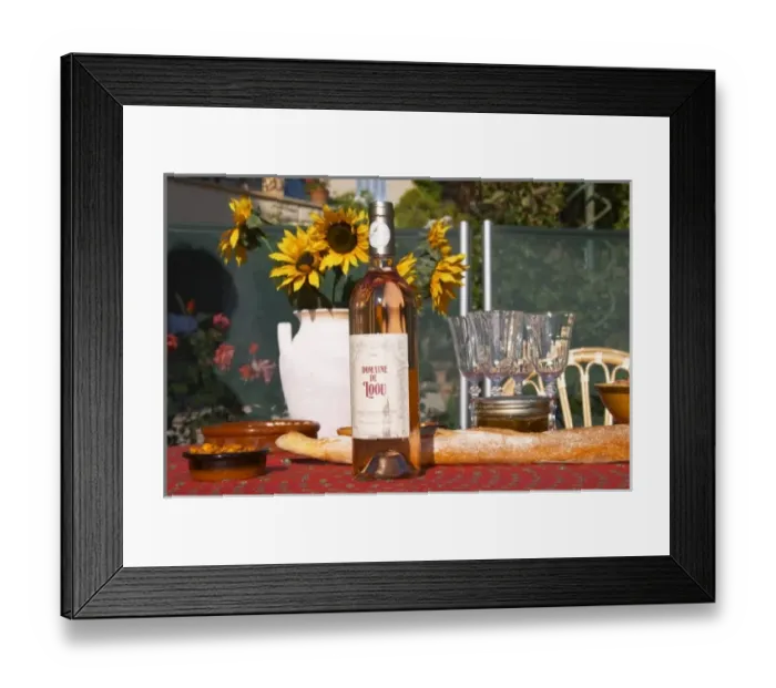 Framed Print : Table with wine aperitif and appetizers, bottle of Domaine Loou rose wine. Clos des