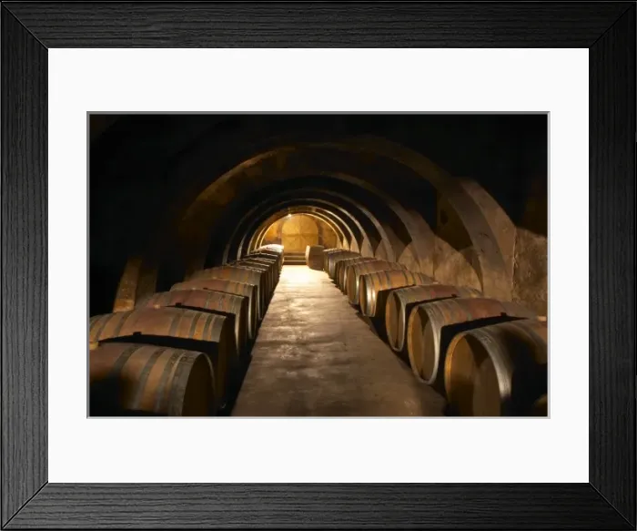 Framed Print : The barrel aging cellar with lines of barriques and dramatic lighting. Chateau Mourgues Framed Print : The barrel aging cellar with lines of barriques and dramatic lighting. Chateau Mourgues