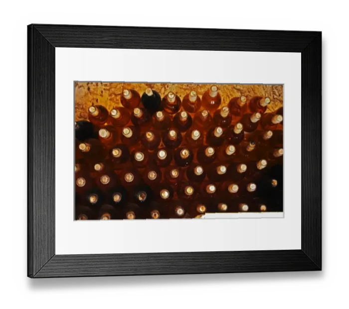Framed Print : Bottles of sauternes stacked hig, shining golden in the cellar light Chateau de Cerons