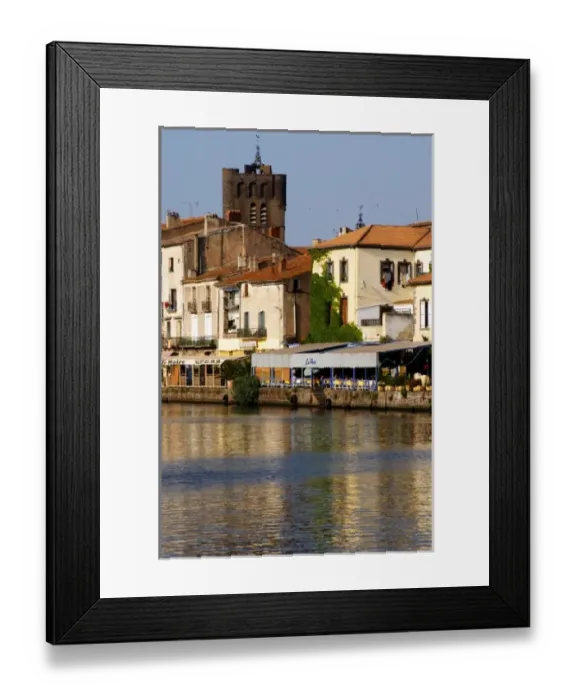 Framed Print : Restaurants along the l Herault river. L Herault river. Agde town. Languedoc