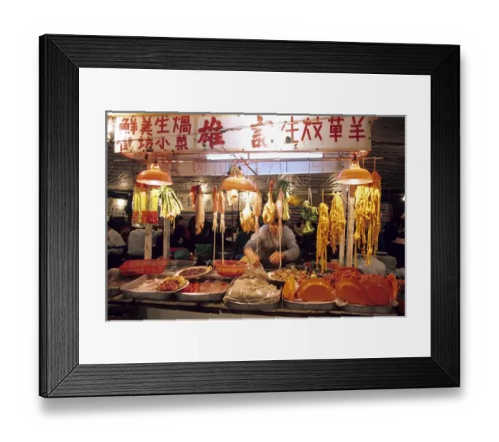 Framed Print : A man works at a night market selling meat and fish in Hong Kong Framed Print : A man works at a night market selling meat and fish in Hong Kong