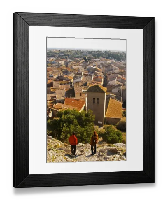Framed Print : Gruissan village. La Clape. Languedoc. Village roof tops with tiles. A tourist couple