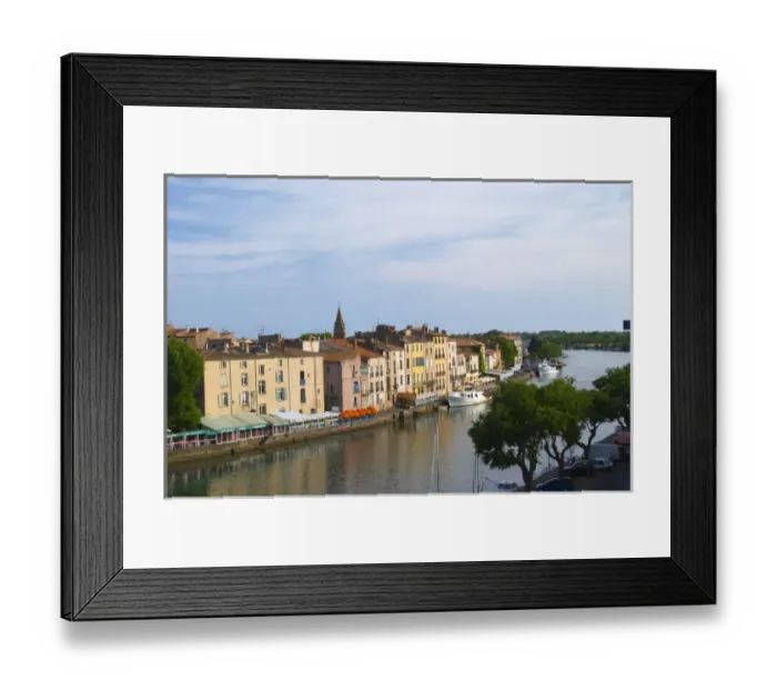 Framed Print : Restaurants along the l Herault river. L Herault river. Agde town. Languedoc