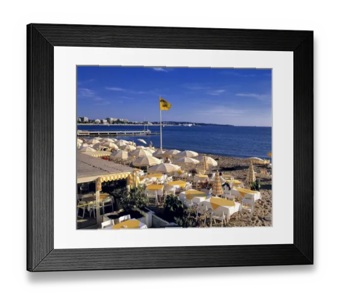 Framed Print : Europe, France, Cannes. The yellow stripped umbrellas on the beach at Cannes awaits Framed Print : Europe, France, Cannes. The yellow stripped umbrellas on the beach at Cannes awaits