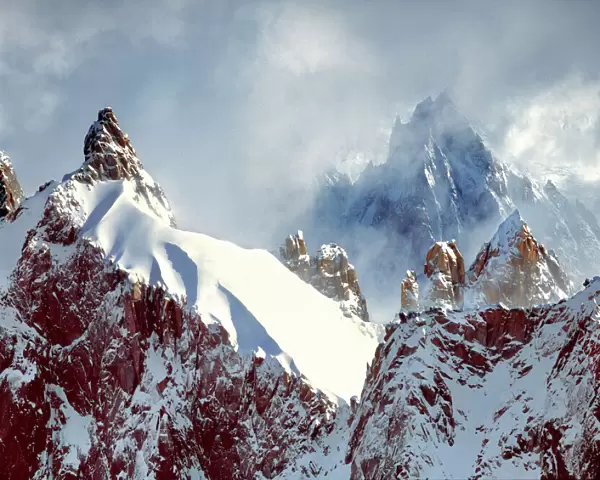 Europe, France, Chamonix. Jagged spires reach for the clouds at Aiguilles du Midi above Chamonix