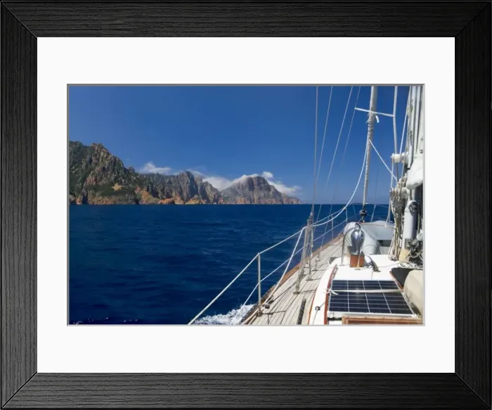 Framed Print : France, Corsica. Sailboat approaching Cape Rossu (Capu Rossu) in Golfe de Porto. Mediterranean Sea Framed Print : France, Corsica. Sailboat approaching Cape Rossu (Capu Rossu) in Golfe de Porto. Mediterranean Sea