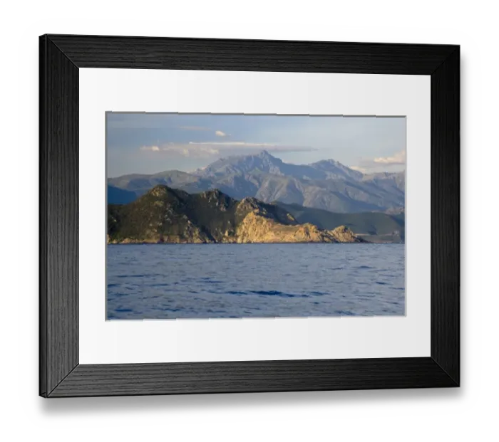 Framed Print : France, Corsica. Red rocks of L ale Rousse (Red Island) below mountainous interior Framed Print : France, Corsica. Red rocks of L ale Rousse (Red Island) below mountainous interior