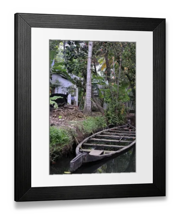 Framed Print : Asia, India, Kerala (Backwaters). A flooded boat rests alongside a Kerala Backwaters canal