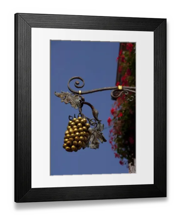 Framed Print : Germany, Rothenburg. Traditional hanging sign, Franconian grapes in front of famous