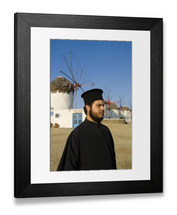 Framed Print : White and blue windmills with a Greek Orthodox priest on the island of Mykonos, Greece Framed Print : White and blue windmills with a Greek Orthodox priest on the island of Mykonos, Greece