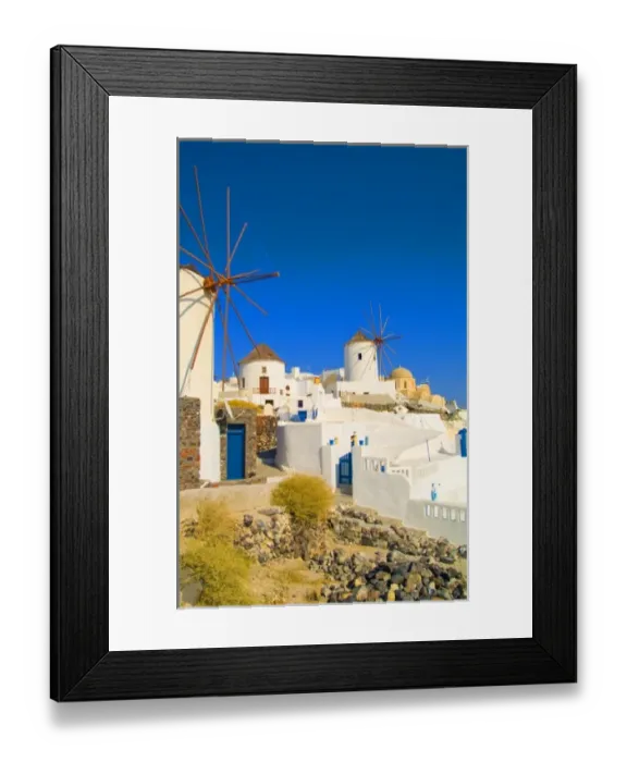 Framed Print : The white buildings and the windmills on the mountain cliffs of Oia, Santorini, Greece Framed Print : The white buildings and the windmills on the mountain cliffs of Oia, Santorini, Greece