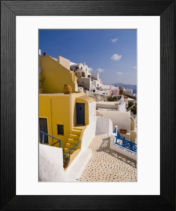 Framed Print : The beautiful colorful buildings on the mountain cliffs of the small isolated romantic city of Oia Framed Print : The beautiful colorful buildings on the mountain cliffs of the small isolated romantic city of Oia