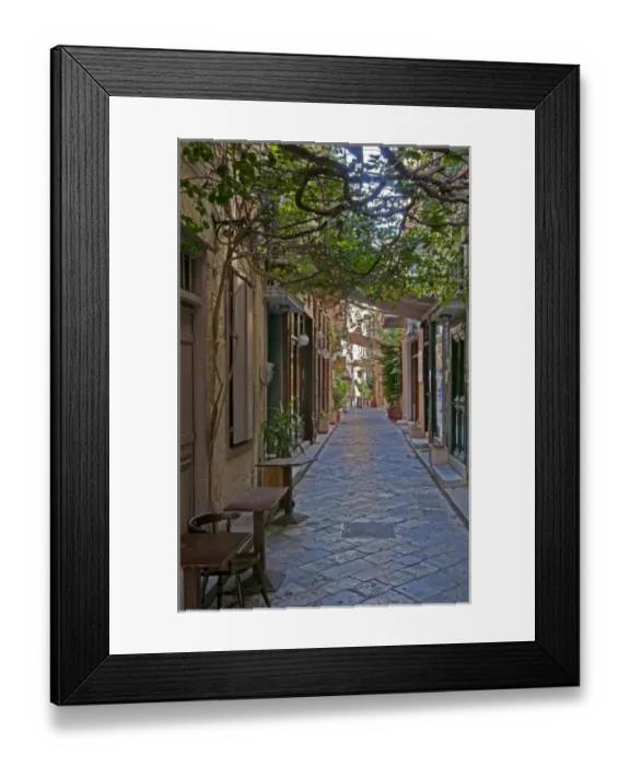 Framed Print : Hermoupolis, Syros Island, Greece. Overhanging plants on quaint downtown street