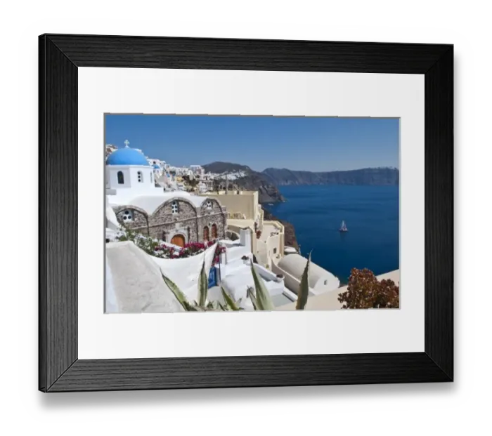 Framed Print : Beautiful Oia in Greek Island of Santorini Greece and the white buildings looking Framed Print : Beautiful Oia in Greek Island of Santorini Greece and the white buildings looking