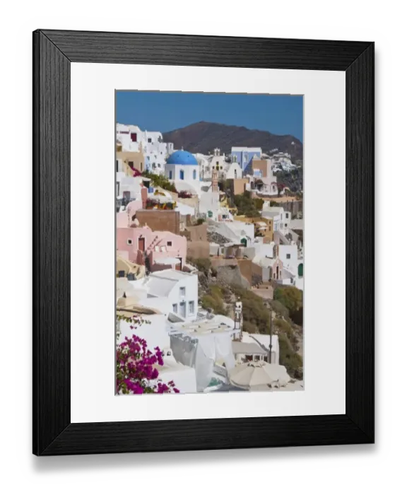 Framed Print : Beautiful Oia in Greek Island of Santorini Greece and the white buildings looking Framed Print : Beautiful Oia in Greek Island of Santorini Greece and the white buildings looking