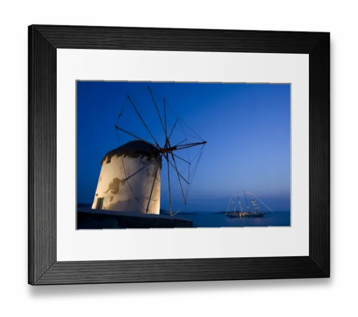 Framed Print : Greece, Mykonos, Hora. Floodlit windmill in foreground and illuminated luxury yacht Framed Print : Greece, Mykonos, Hora. Floodlit windmill in foreground and illuminated luxury yacht