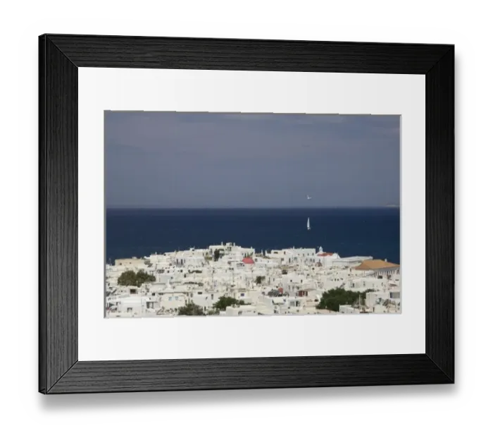 Framed Print : Greece, Mykonos, Hora. Overlook of town of and sailboat on ocean