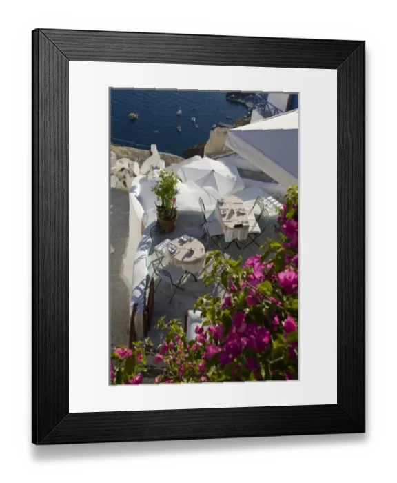 Framed Print : Greece, Santorini, Thira, Oia. Looking down on patio tables set for dinner Framed Print : Greece, Santorini, Thira, Oia. Looking down on patio tables set for dinner