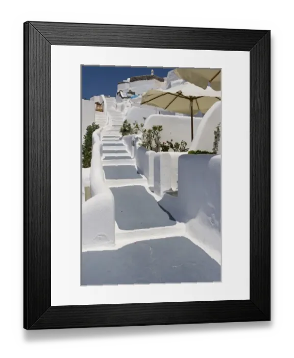 Framed Print : Greece, Santorini, Thira, Oia. Grey and white painted stairs leading past open patio umbrellas Framed Print : Greece, Santorini, Thira, Oia. Grey and white painted stairs leading past open patio umbrellas