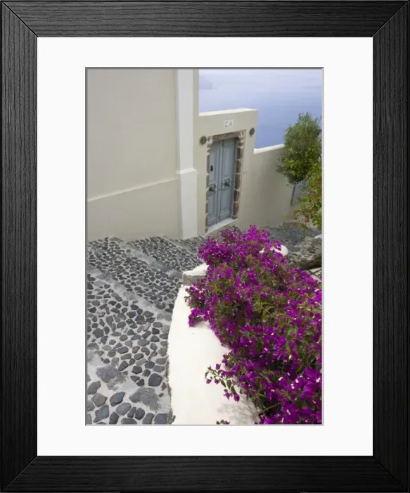 Framed Print : Greece, Santorini, Thira, Oia. Pebbled staircase leading past villa door and bougainvillea