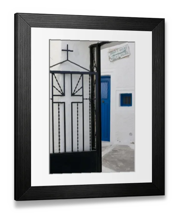 Framed Print : Greece, Santorini. Black iron church gate against white wall