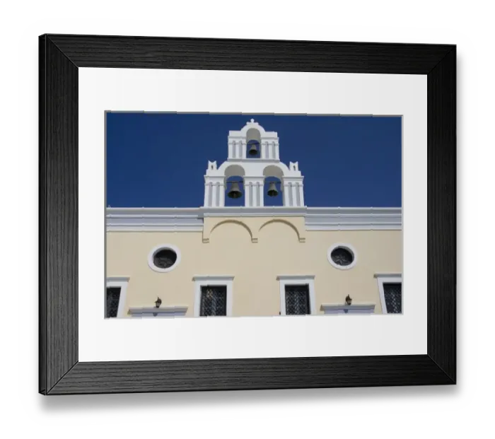 Framed Print : Greece, Santorini. Yellow church wall and white bell tower against dark blue sky