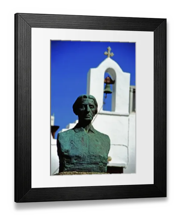 Framed Print : Greece, Aegean Sea, Mykonos. Female statue in front of typical white church bell tower