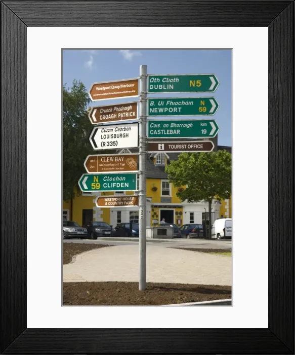 Framed Print : Ireland, County Mayo, Westport. One post holds distance and directional signs in English and Gaelic Framed Print : Ireland, County Mayo, Westport. One post holds distance and directional signs in English and Gaelic