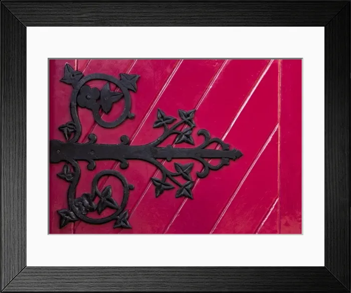 Framed Print : Ireland, Ennis. A decorative black hinge on a bright red door of the new Franciscan Framed Print : Ireland, Ennis. A decorative black hinge on a bright red door of the new Franciscan