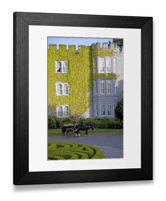 Framed Print : Dromoland Castle Hotel in Ireland with a Coachman stands along side his horse drawn