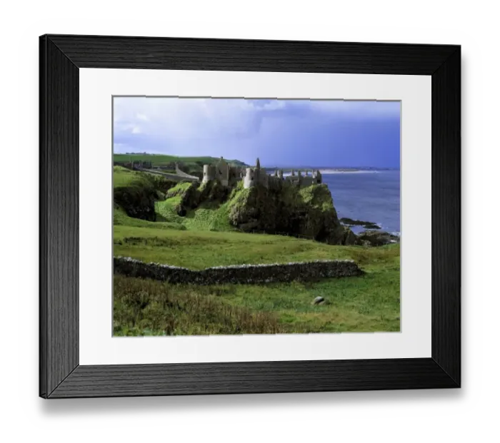 Framed Print : Northern Ireland, County Antrim, Dunluce Castle. Dunluce Castle rises from the emerald