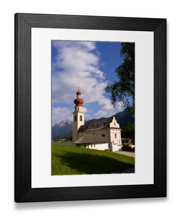 Framed Print : Beautiful St Stephan Church with steeple with fabulous Dolomites mountains behind