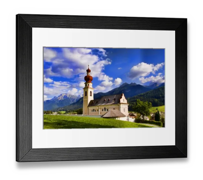 Framed Print : Beautiful St Stephan Church with steeple with fabulous Dolomites mountains behind Framed Print : Beautiful St Stephan Church with steeple with fabulous Dolomites mountains behind