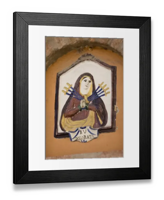 Framed Print : Europe, Italy, Dozza. Ceramic plaque of the Virgin Mary with seven swords piercing her heart